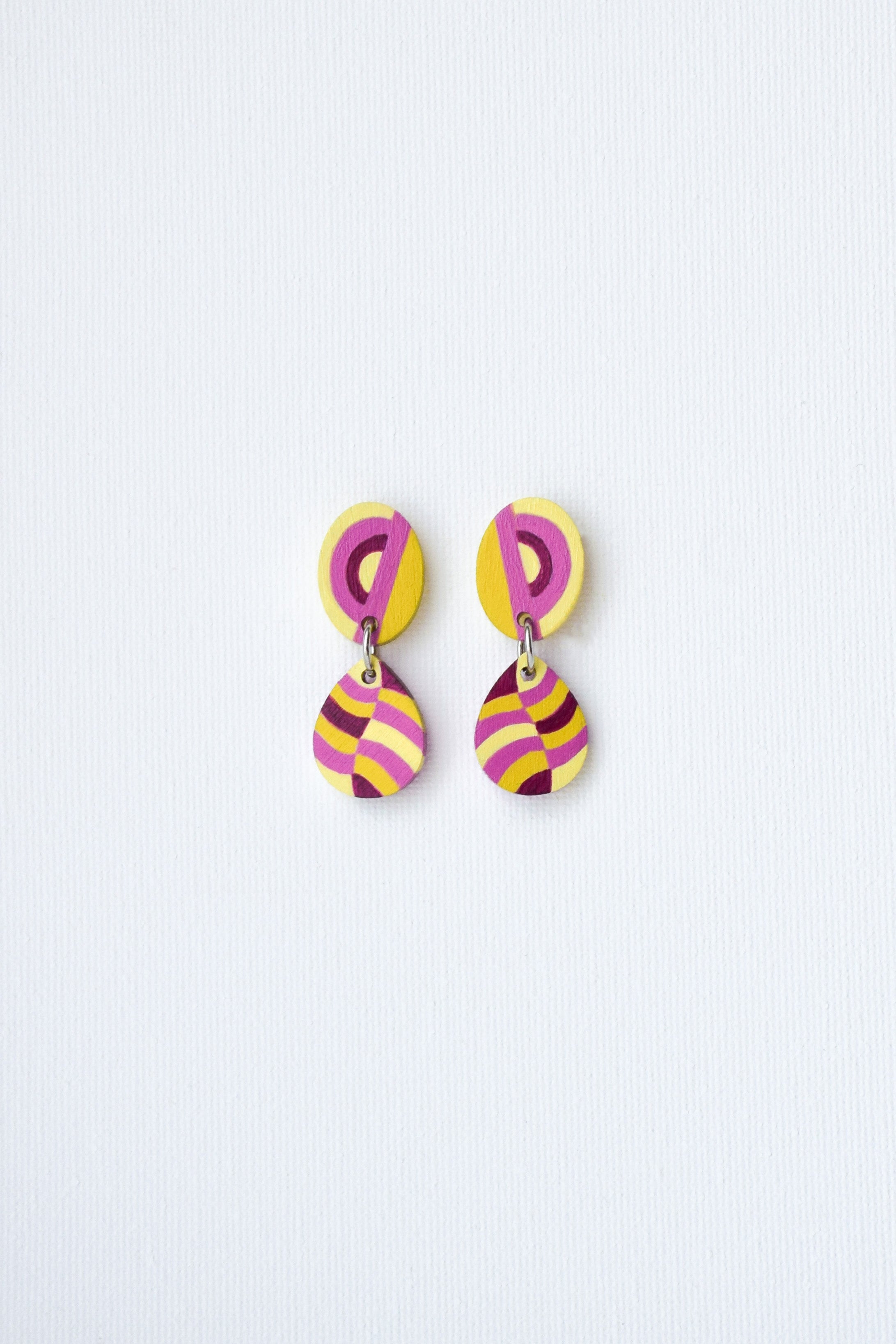 Colorful hand-painted earrings on a light gray background