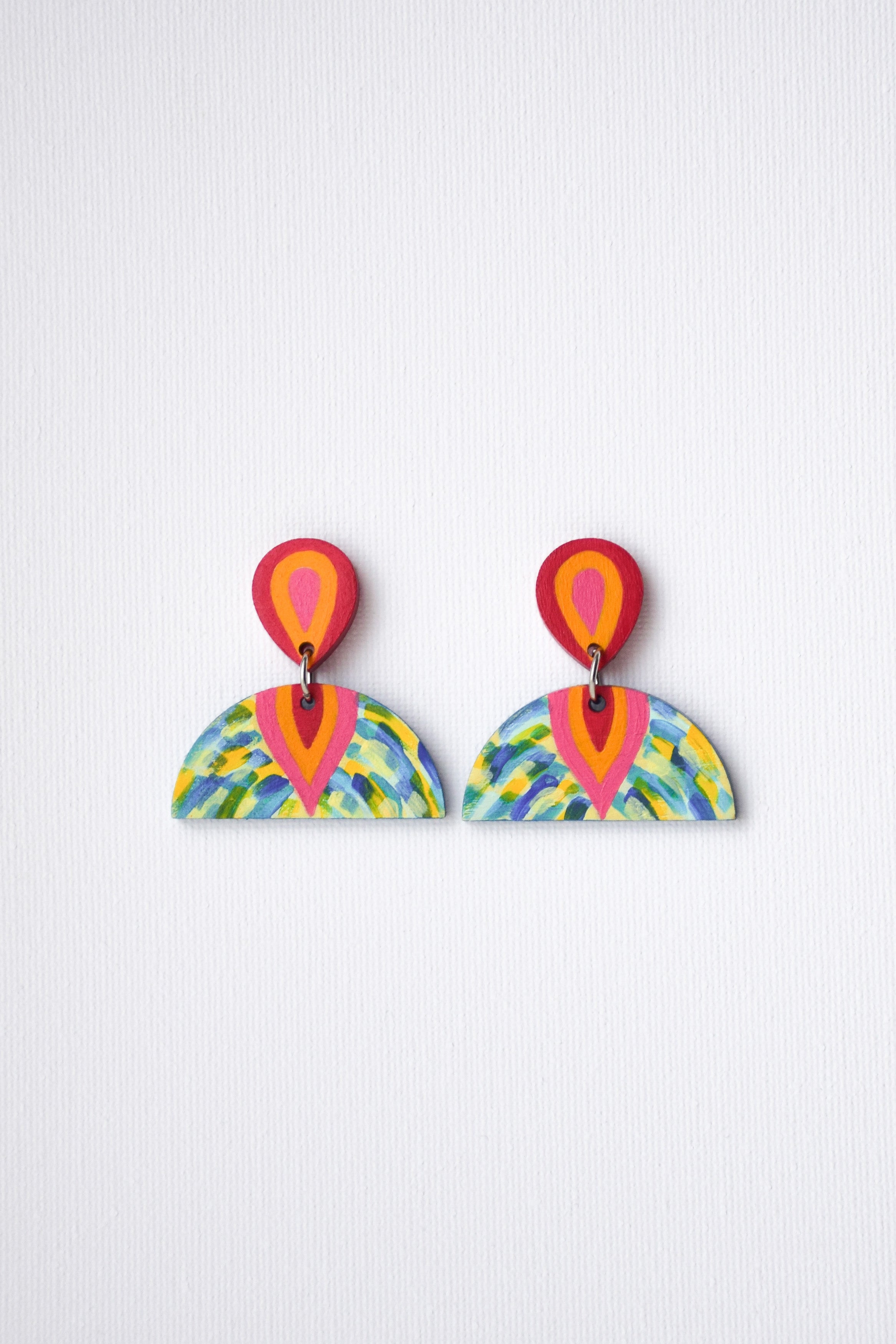 Colorful earrings with a geometric design on a white background