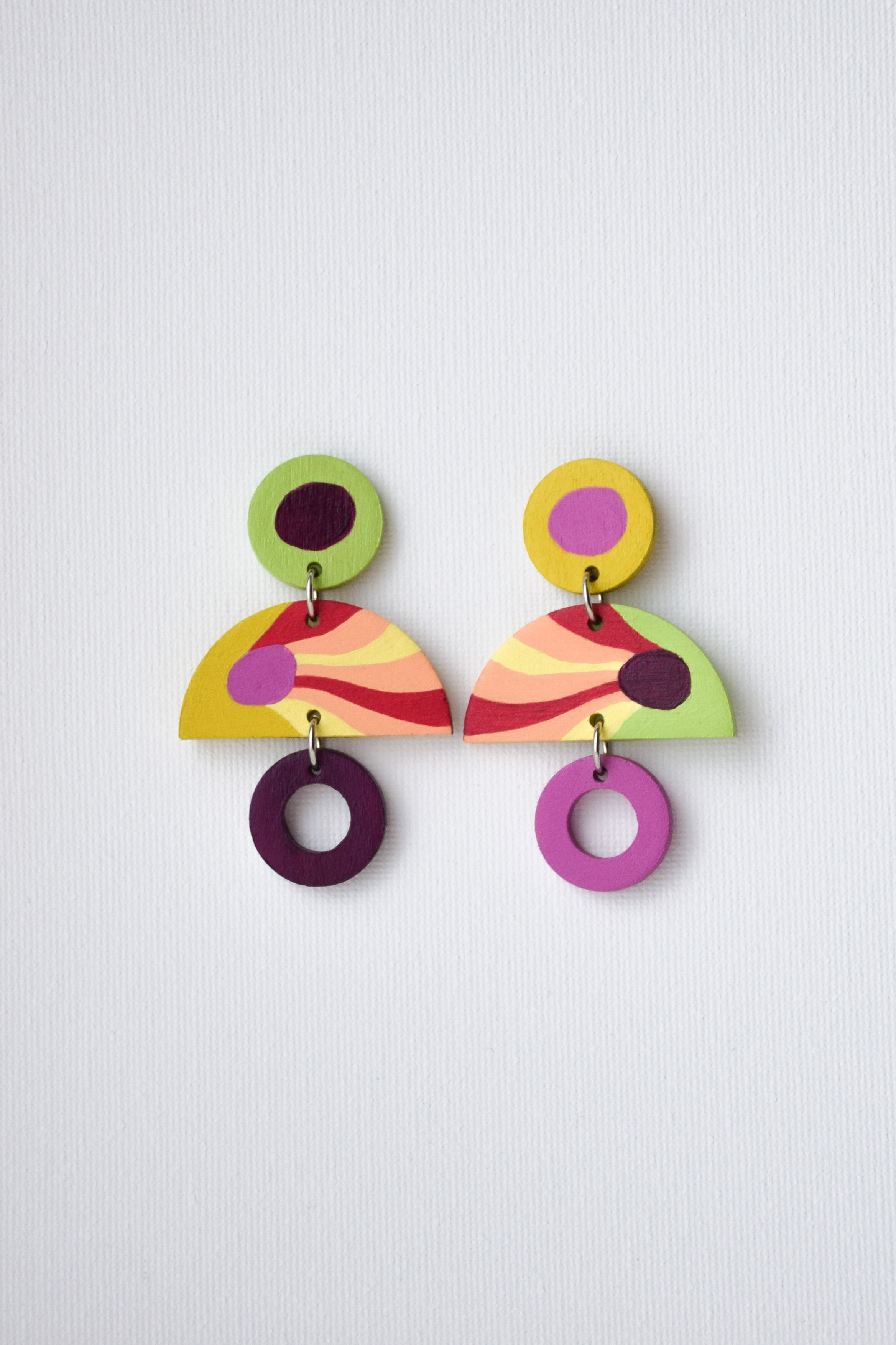 Colorful geometric earrings on a light gray background