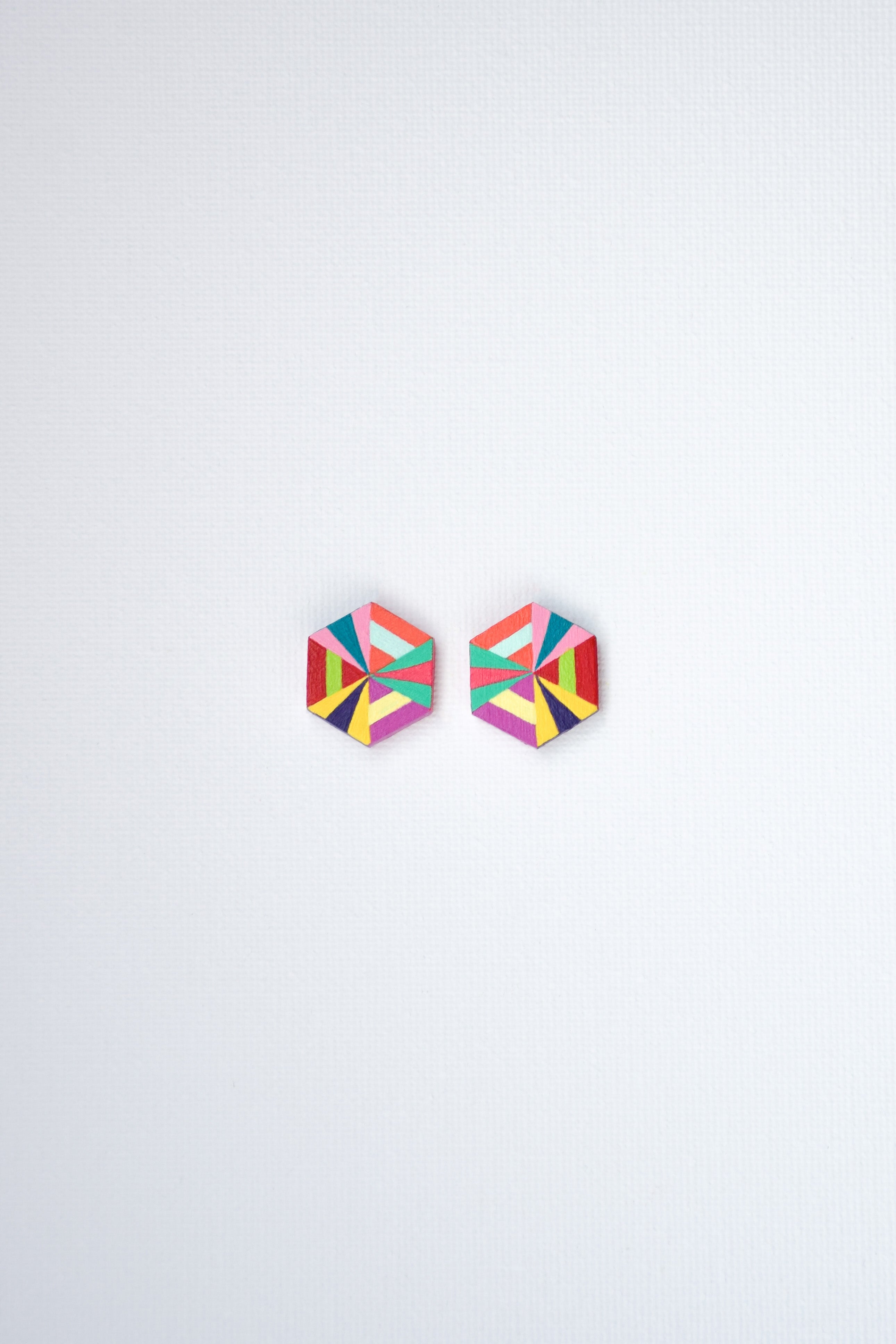Colorful geometric stud earrings on a white background