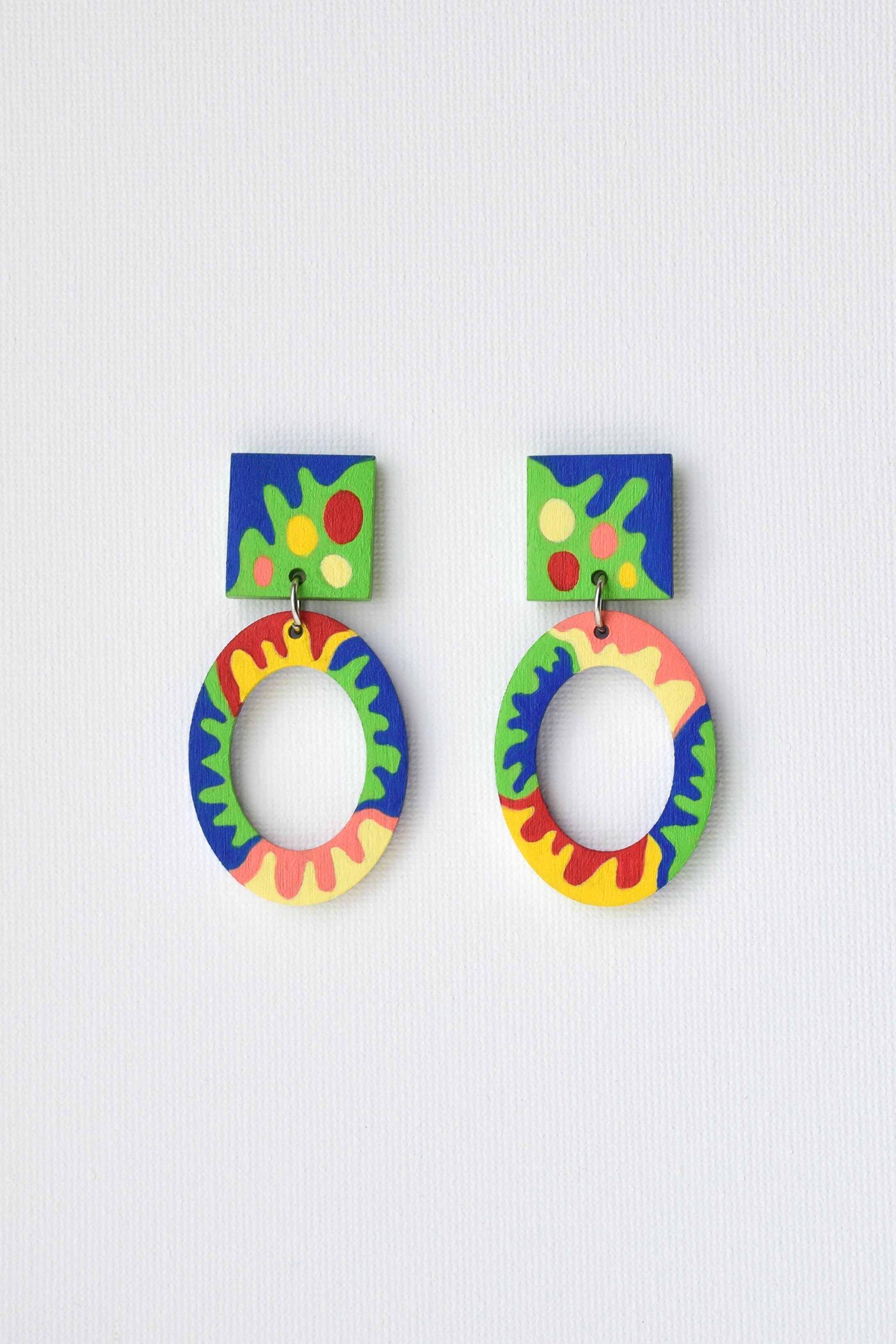 Colorful hoop earrings on a light gray background
