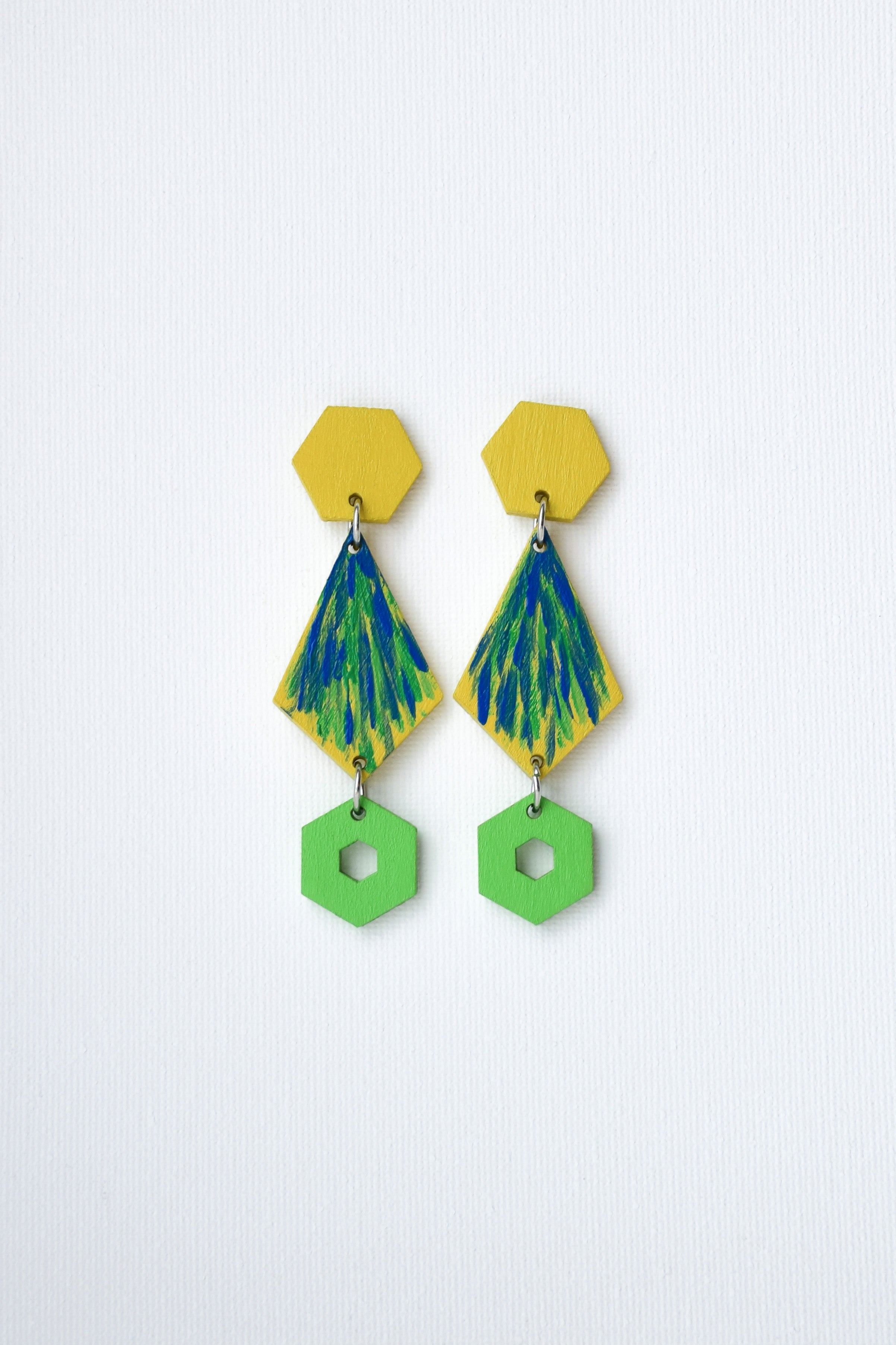 Pair of hand-painted earrings with geometric design on a white background