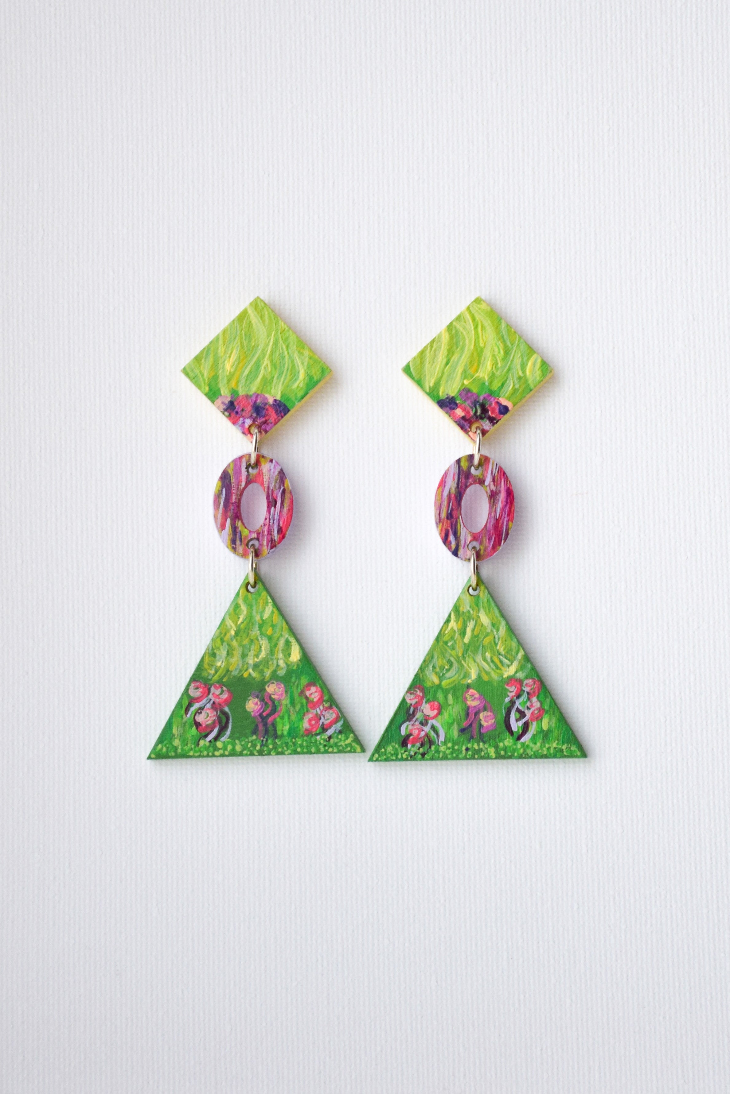 Triangular earrings with floral design on a white background