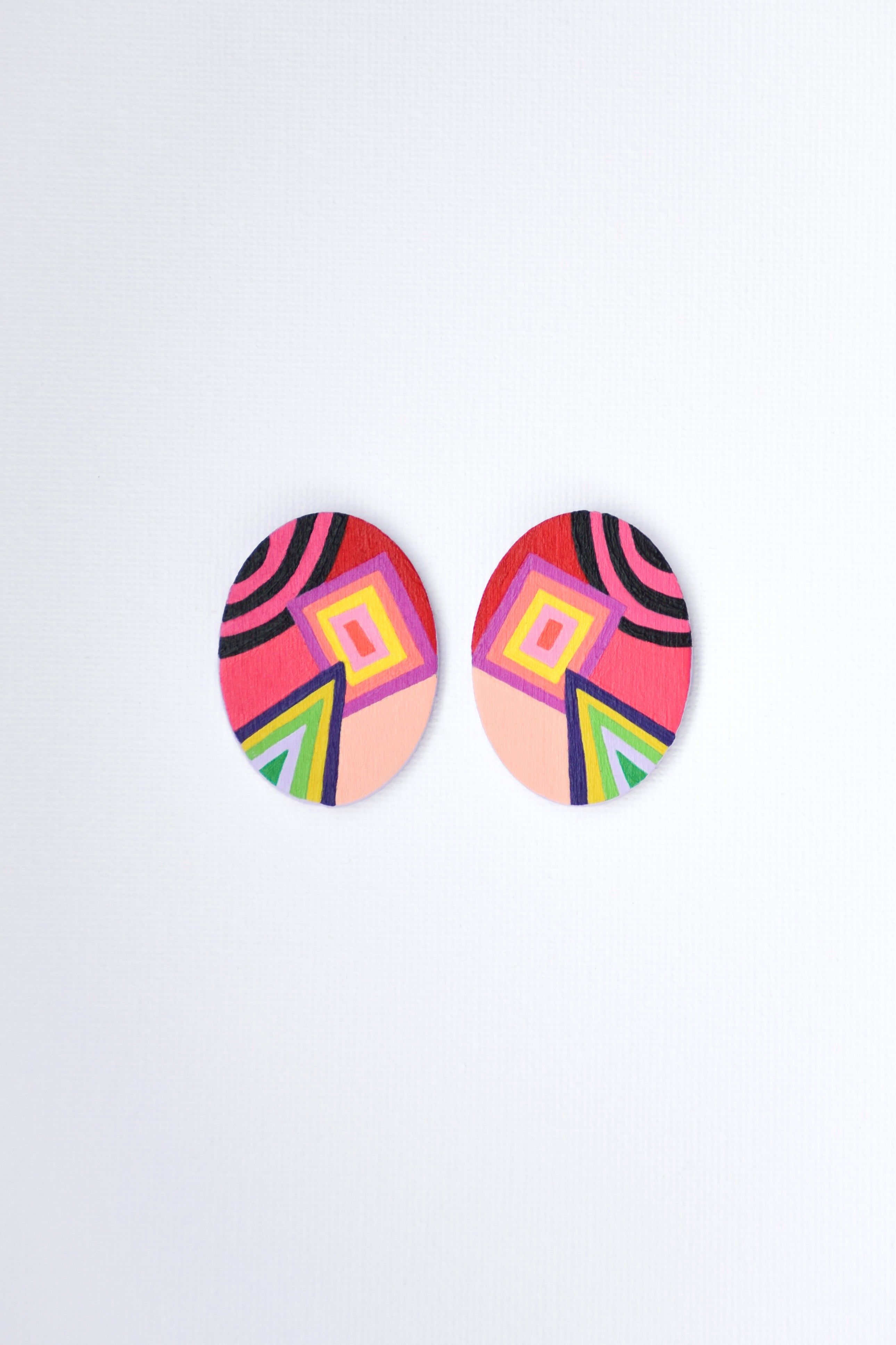 Colorful geometric patterned earrings on a white background