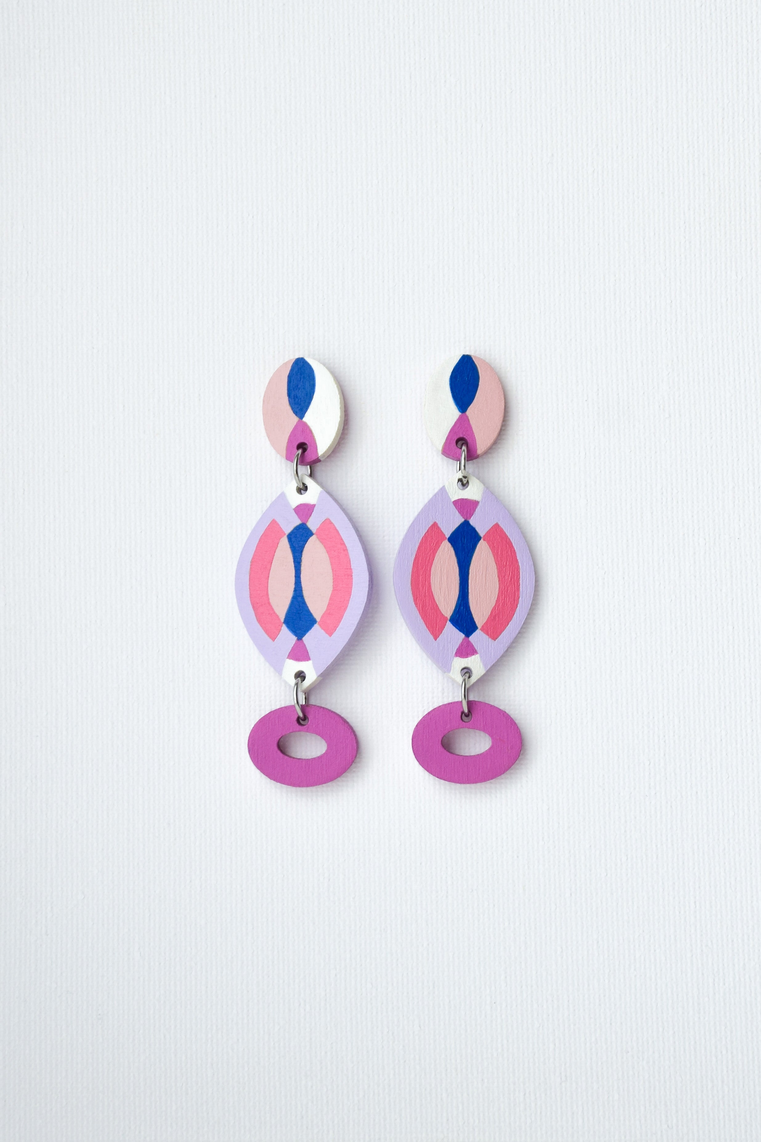 Pair of hand-painted colorful earrings on a light gray background