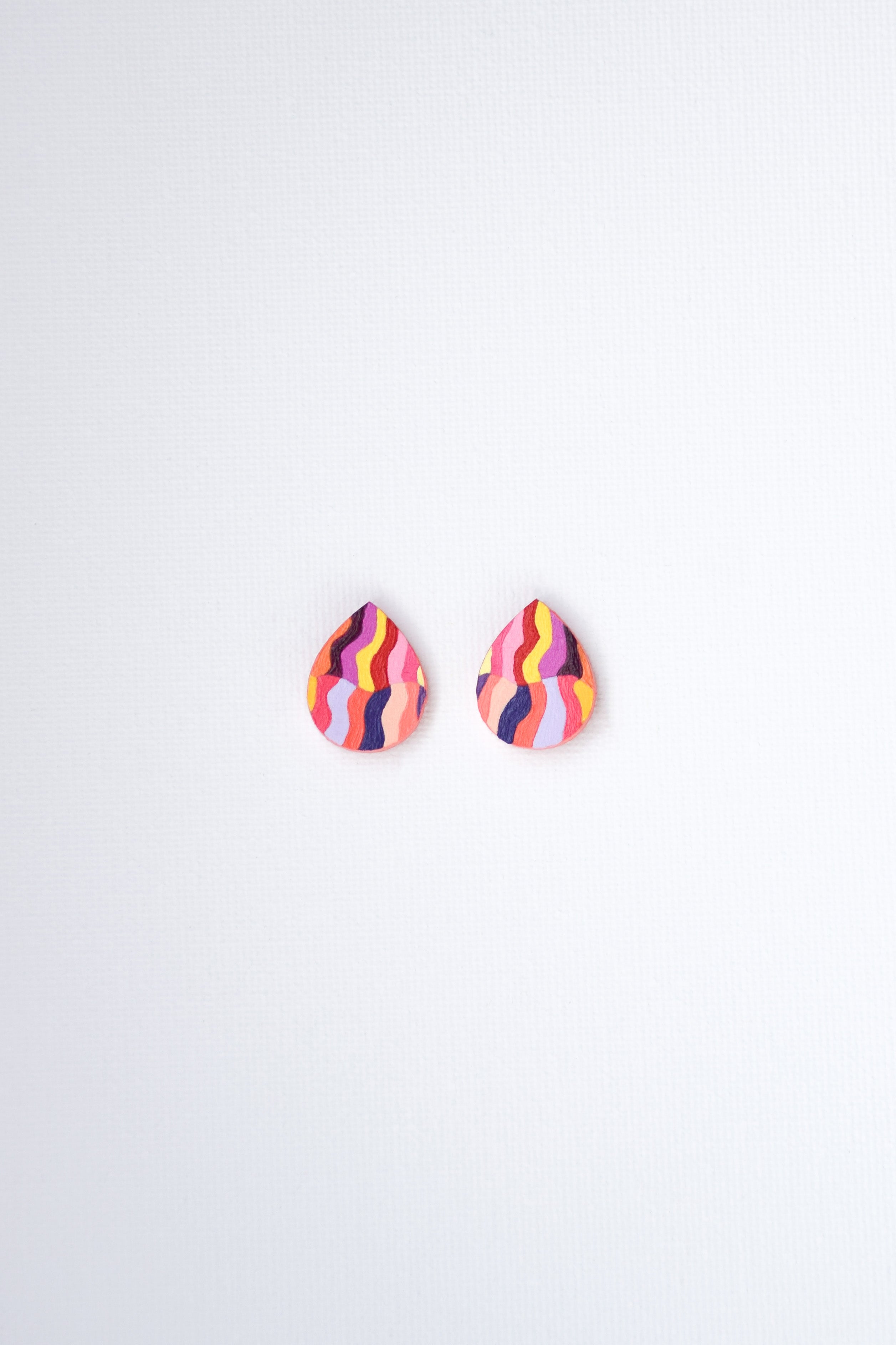 Colorful teardrop-shaped earrings on a white background