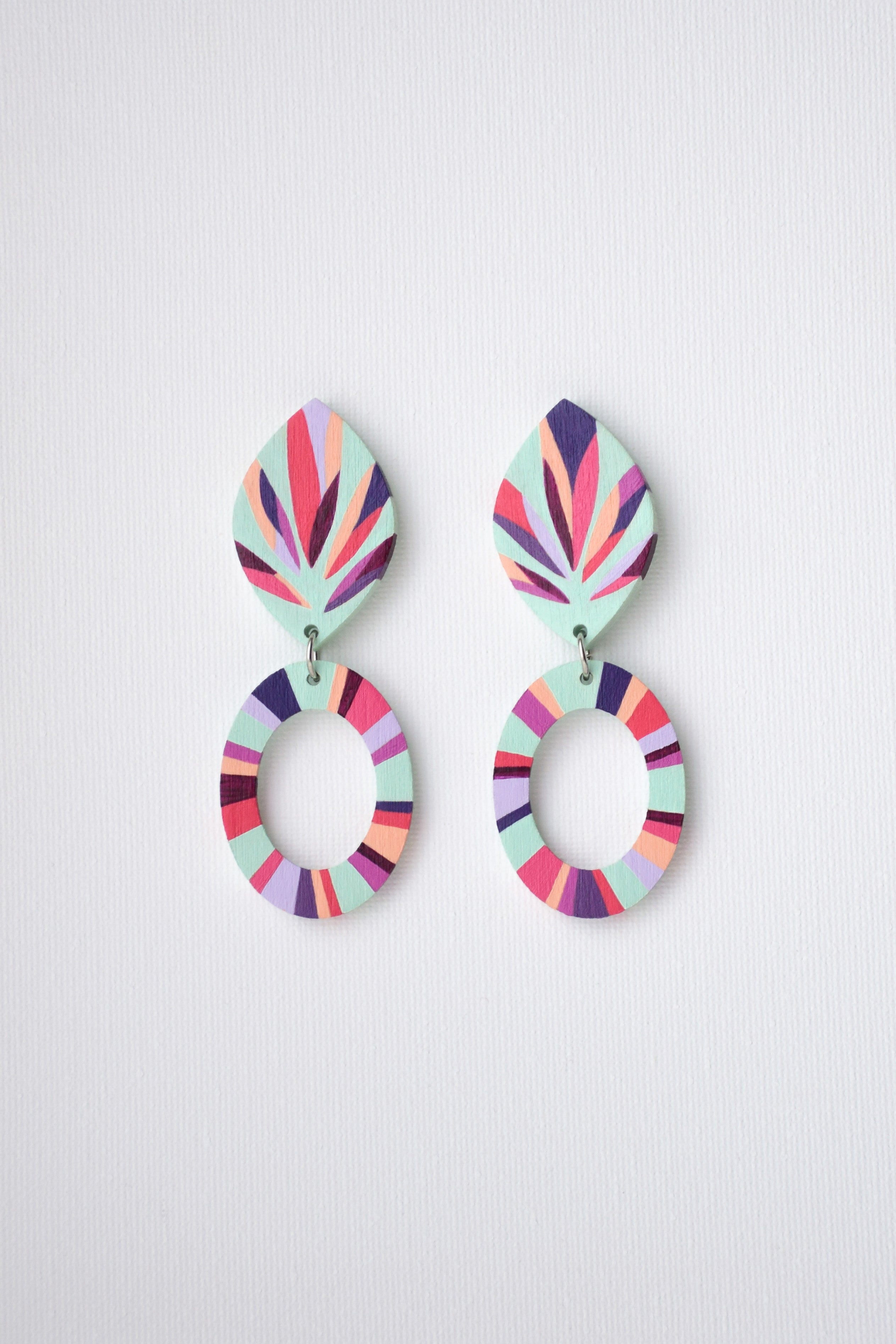 Colorful earrings with a geometric design on a white background