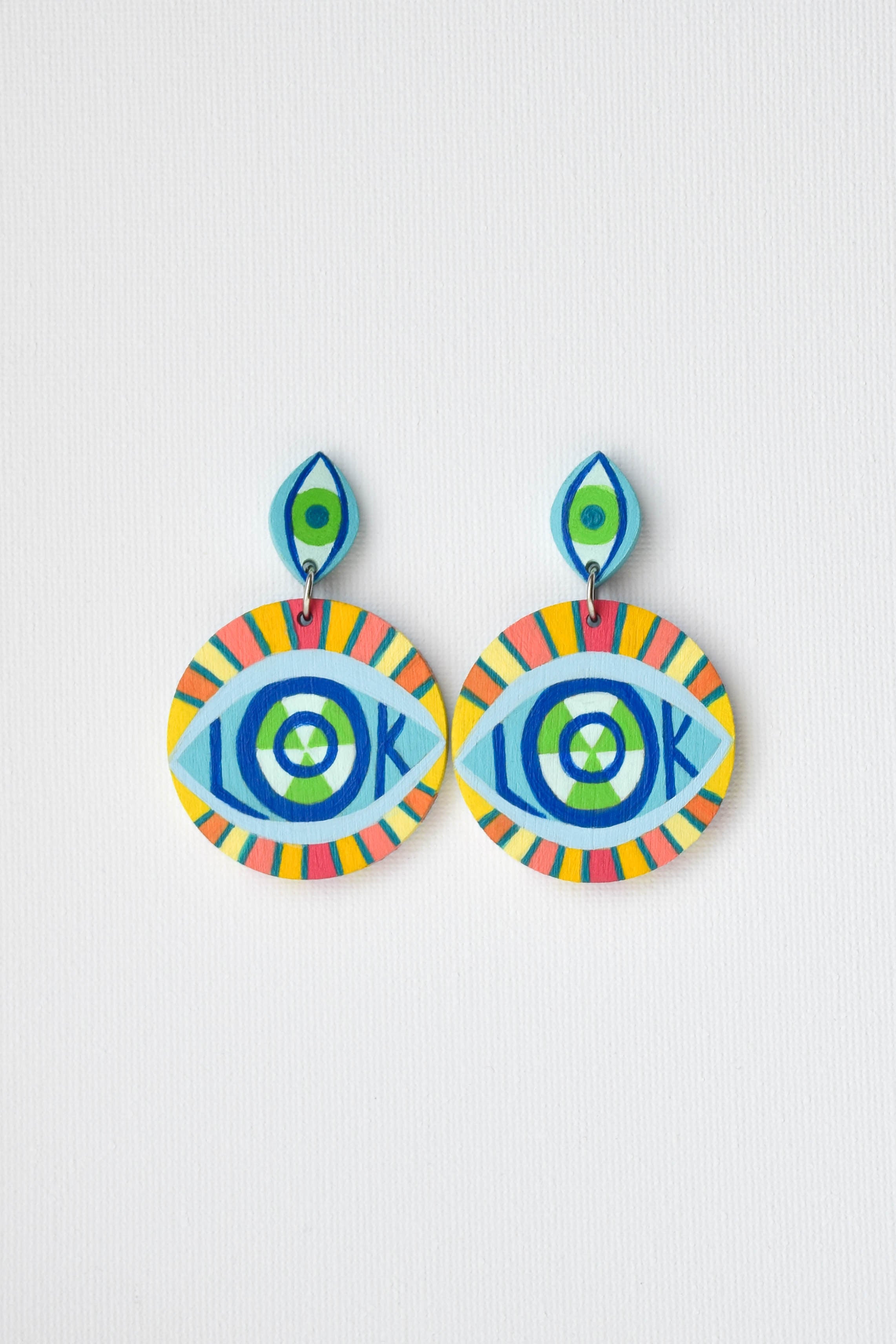 Colorful hand-painted eye-shaped earrings on a light gray background