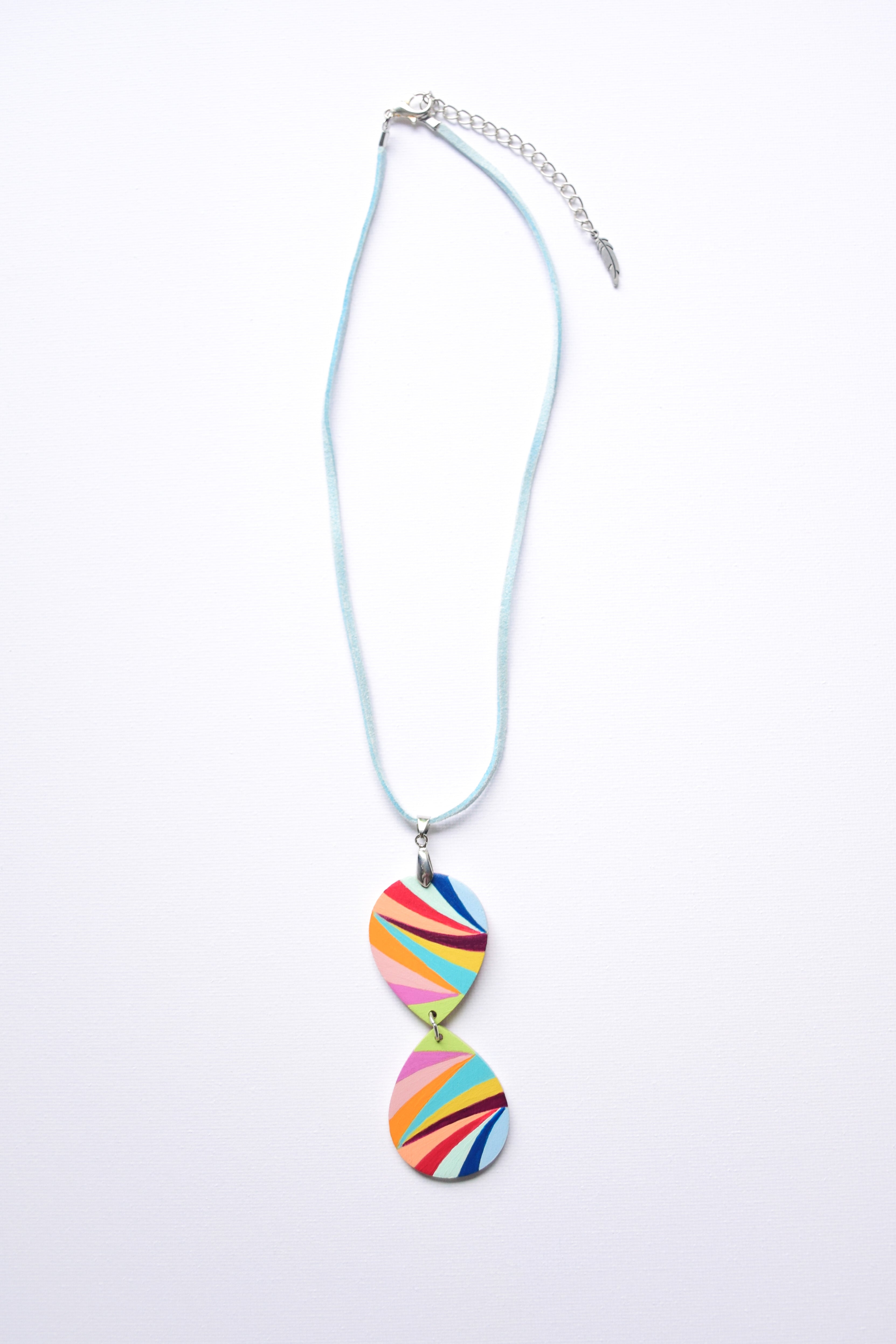 Leather cord necklace with a hand-painted colorful pendant on a white background
