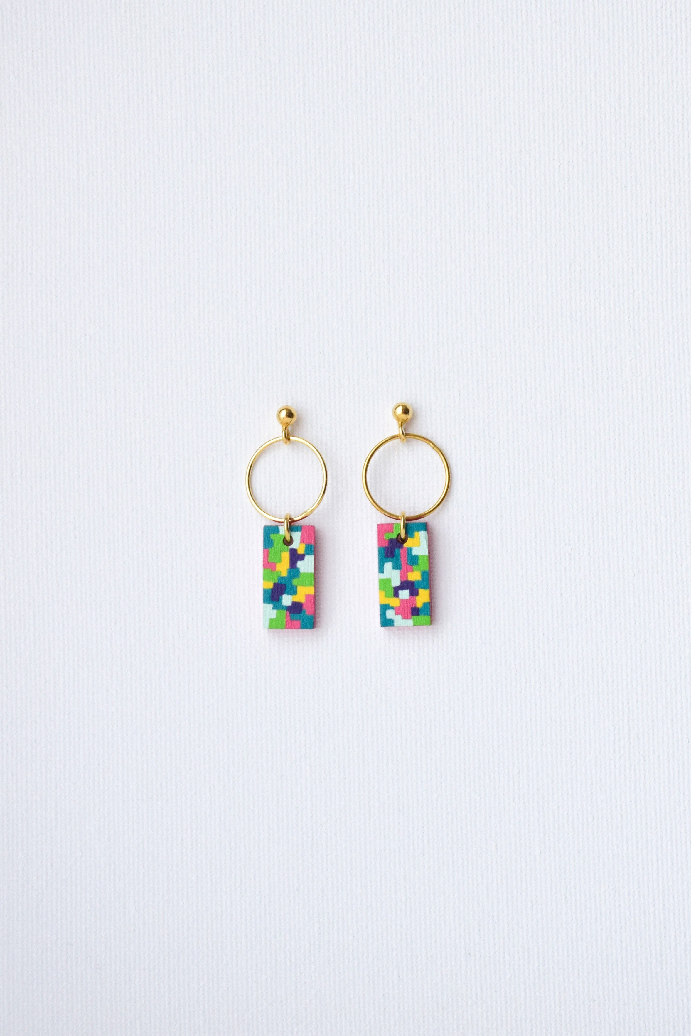 Pair of earrings with colorful rectangular charms on a white background