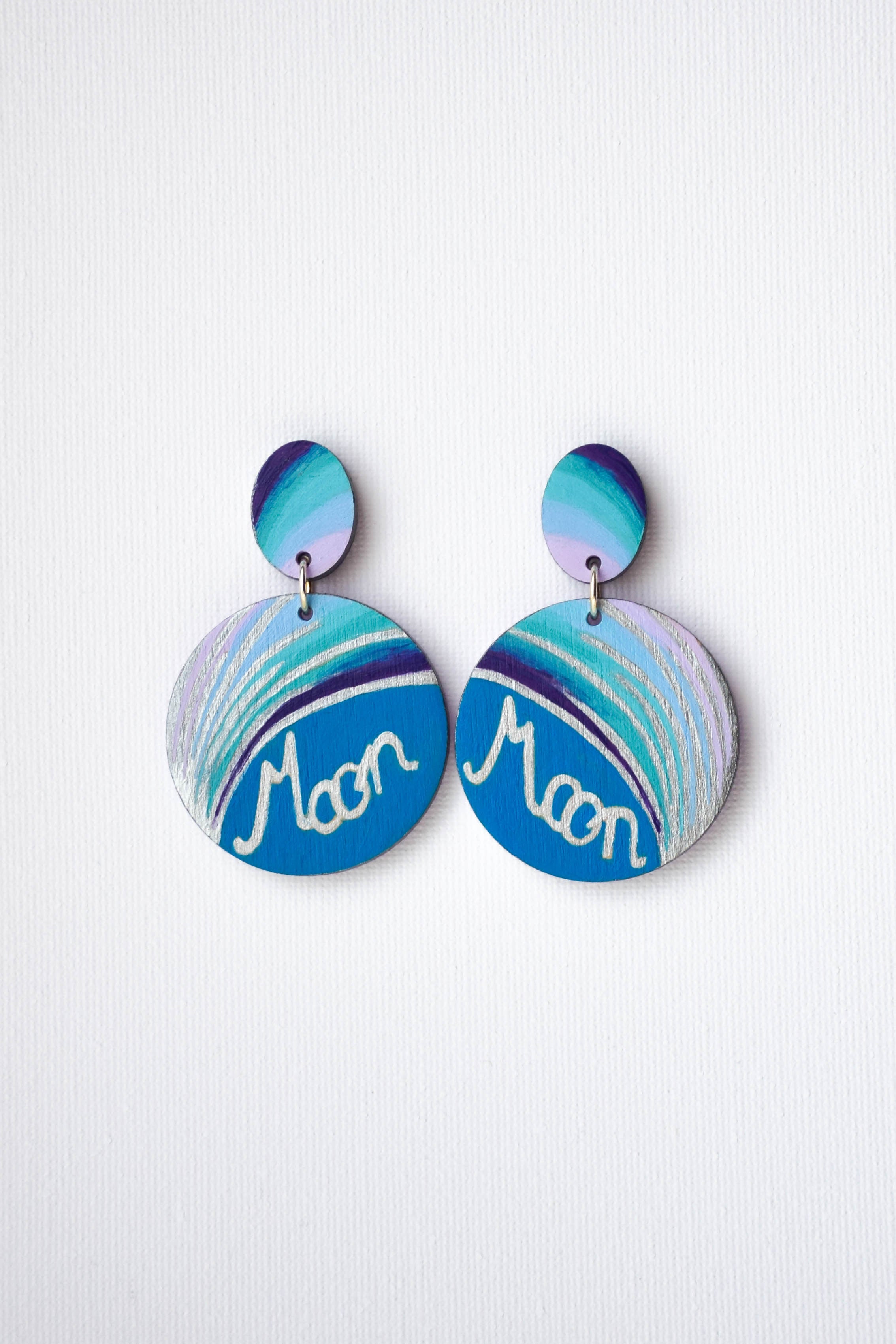 Pair of hand-painted earrings with blue and green gradient design on a white background