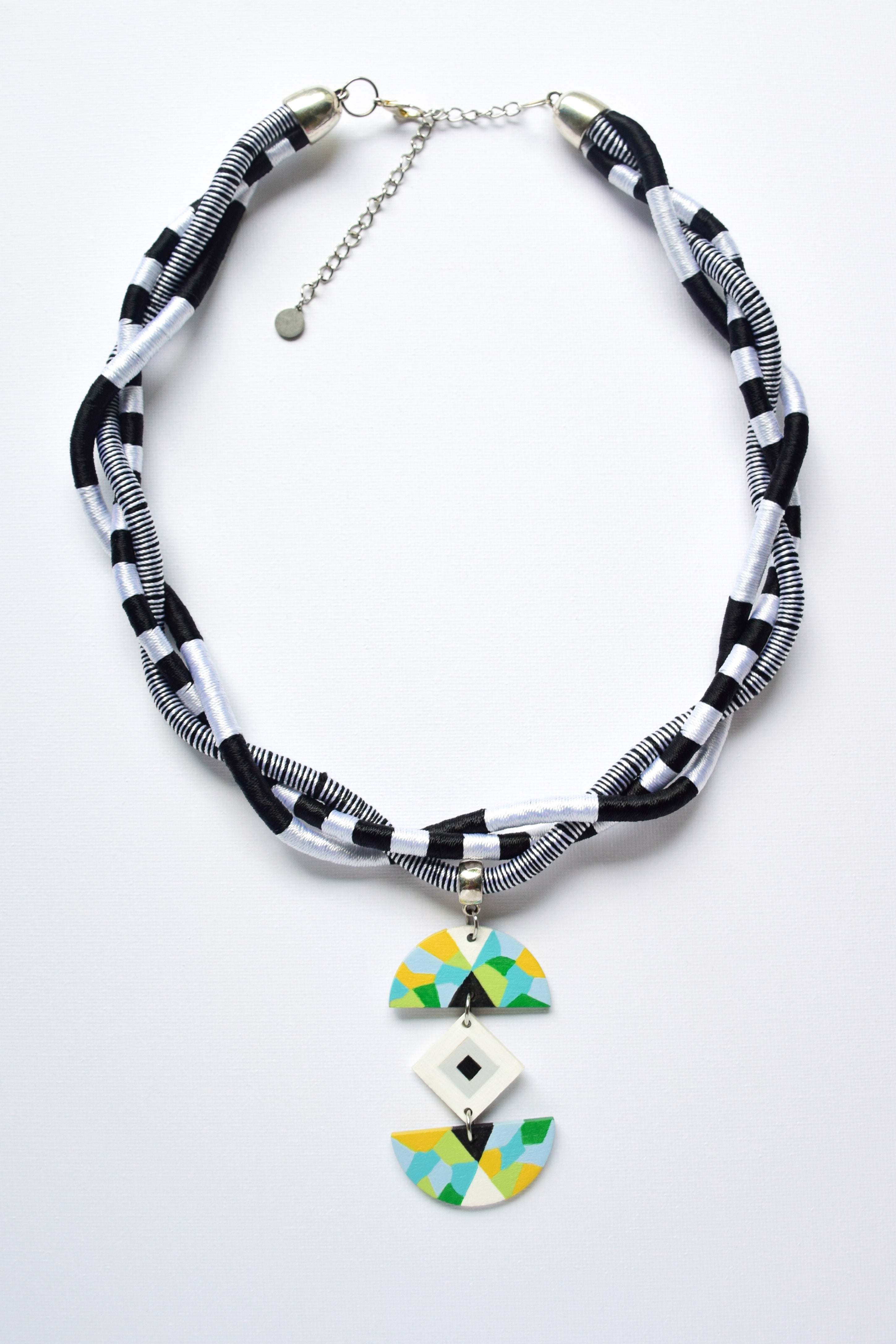 Necklace with geometric pendant on a white background