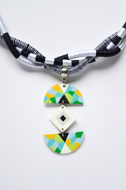 Necklace with geometric pendant on a white background
