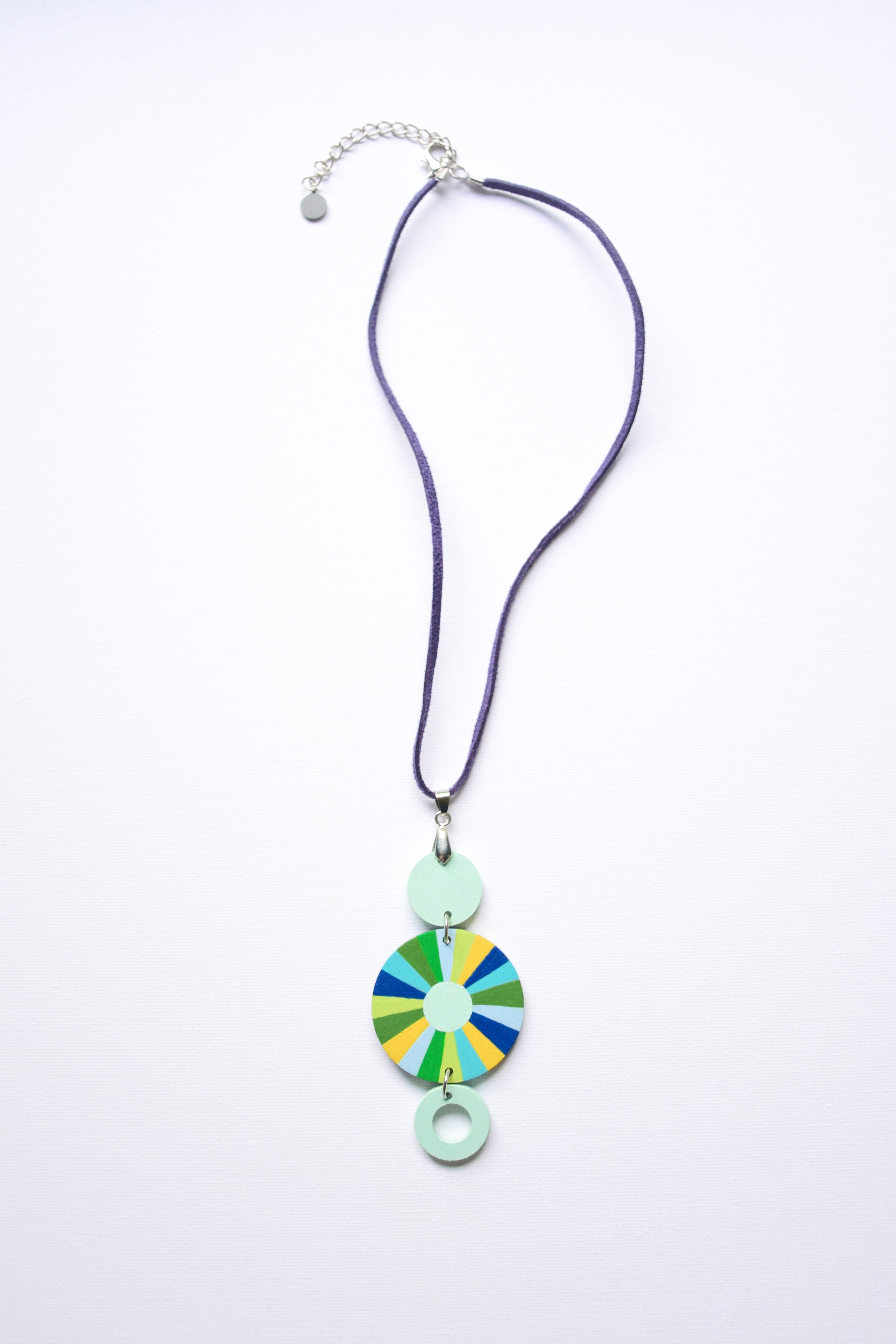 Leather cord necklace with a colorful hand-painted pendant on a white background