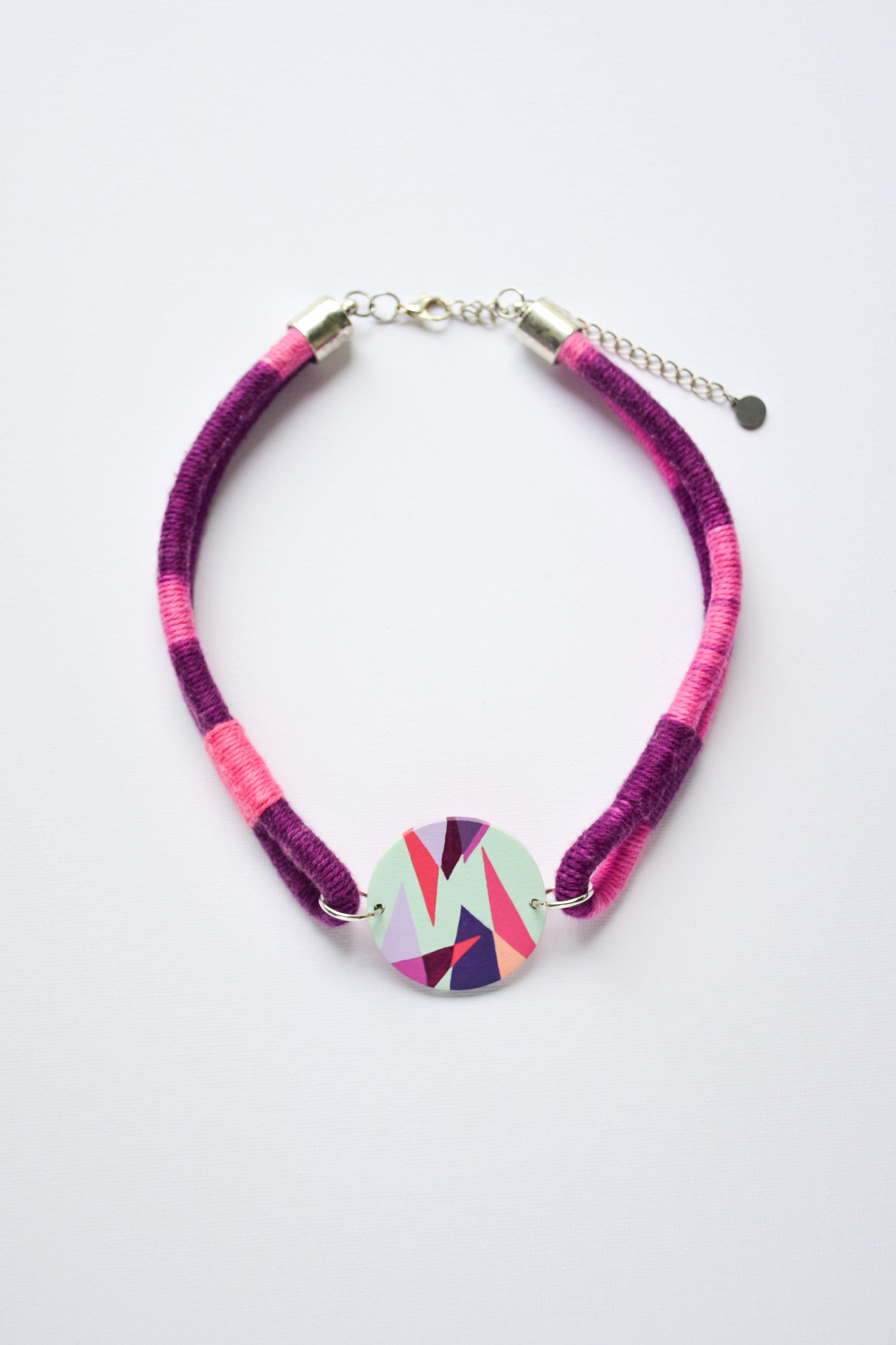 Necklace with a colorful pendant on a white background