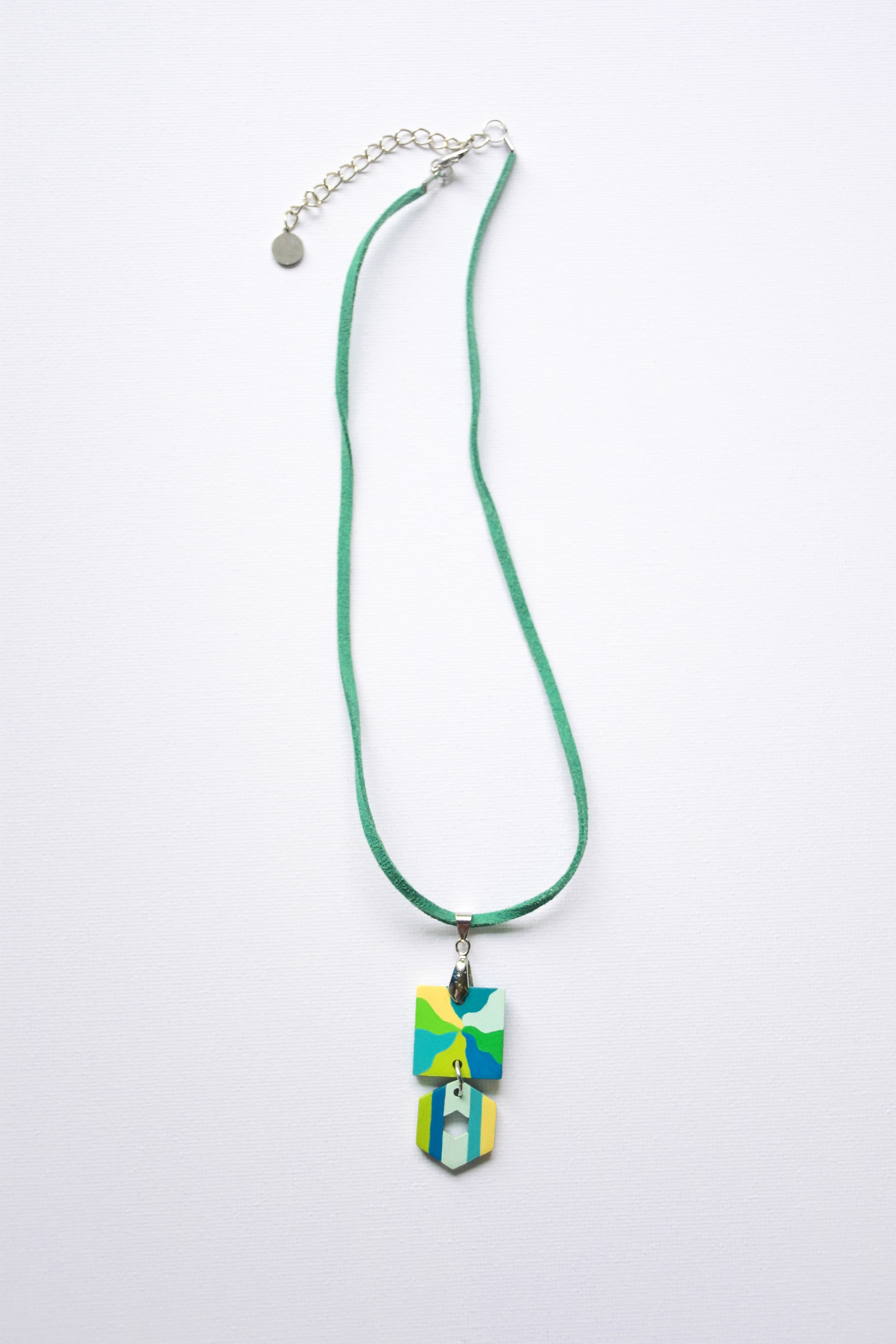 Leather cord necklace with a colorful hand-painted pendant on a white background