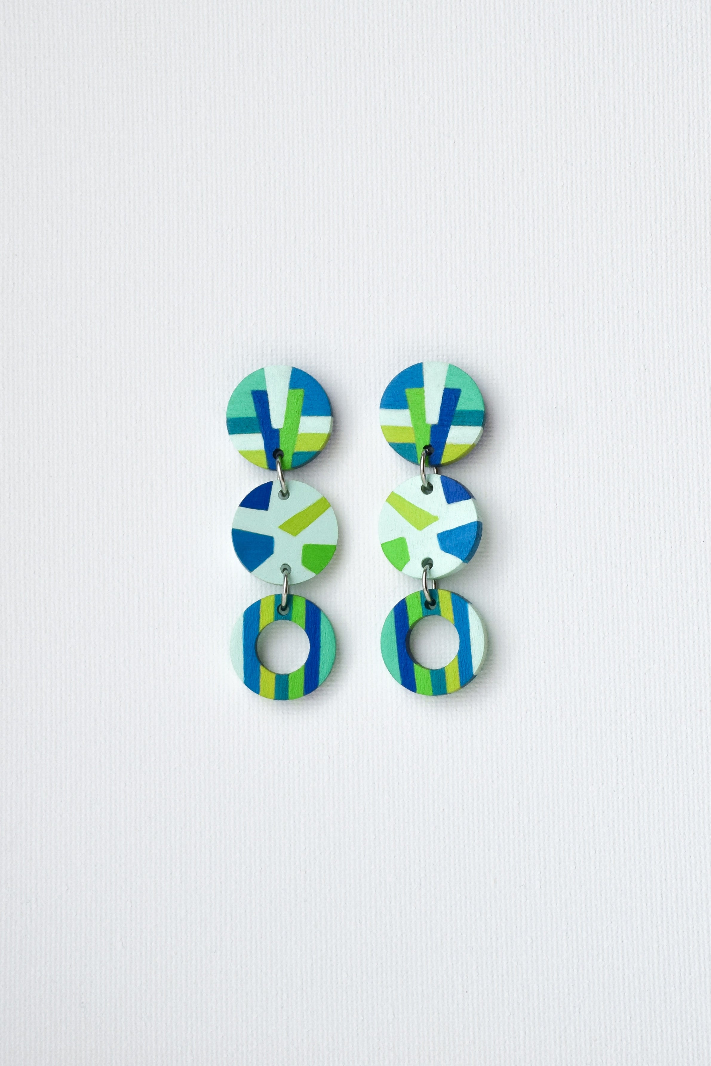 Colorful geometric earrings on a light gray background