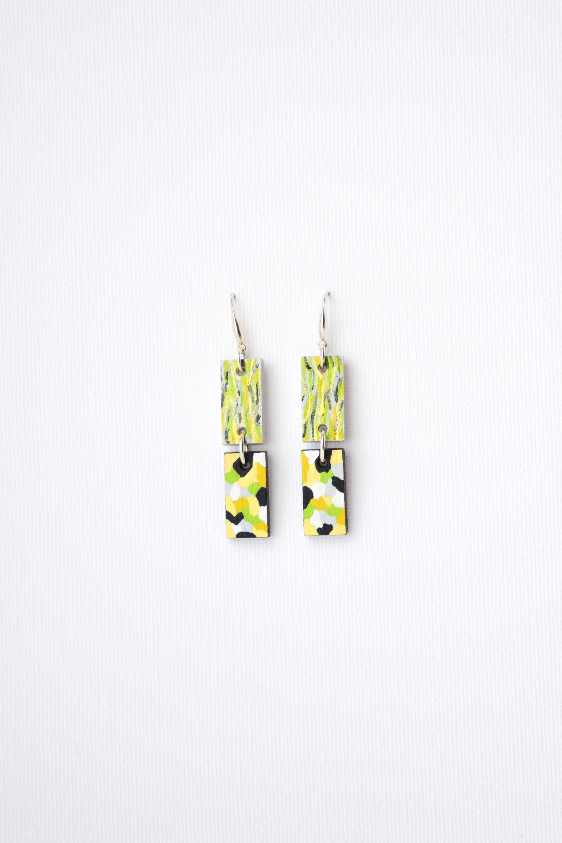 Pair of hand-painted colorful earrings on a white background