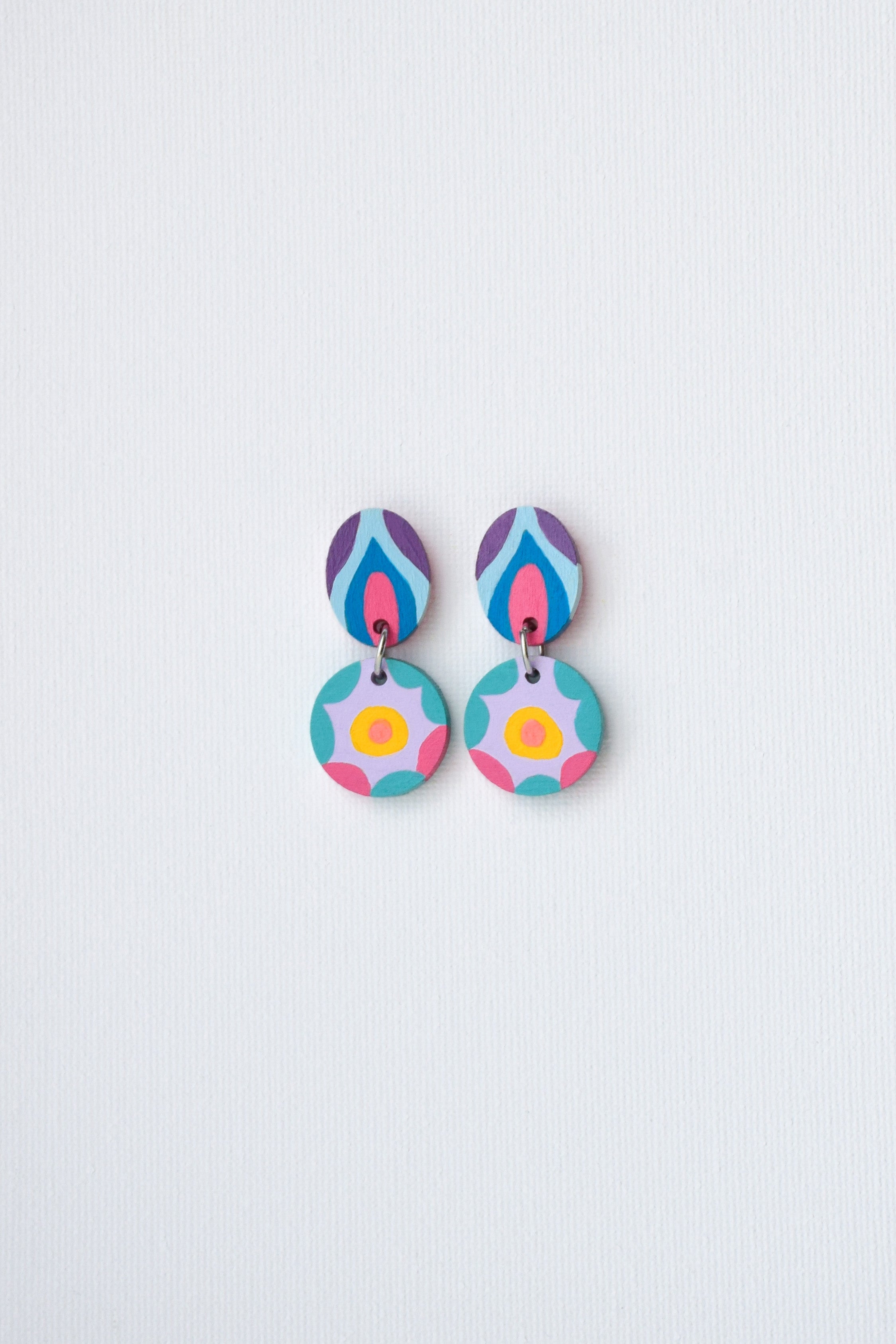 Colorful hand-painted earrings on a light gray background