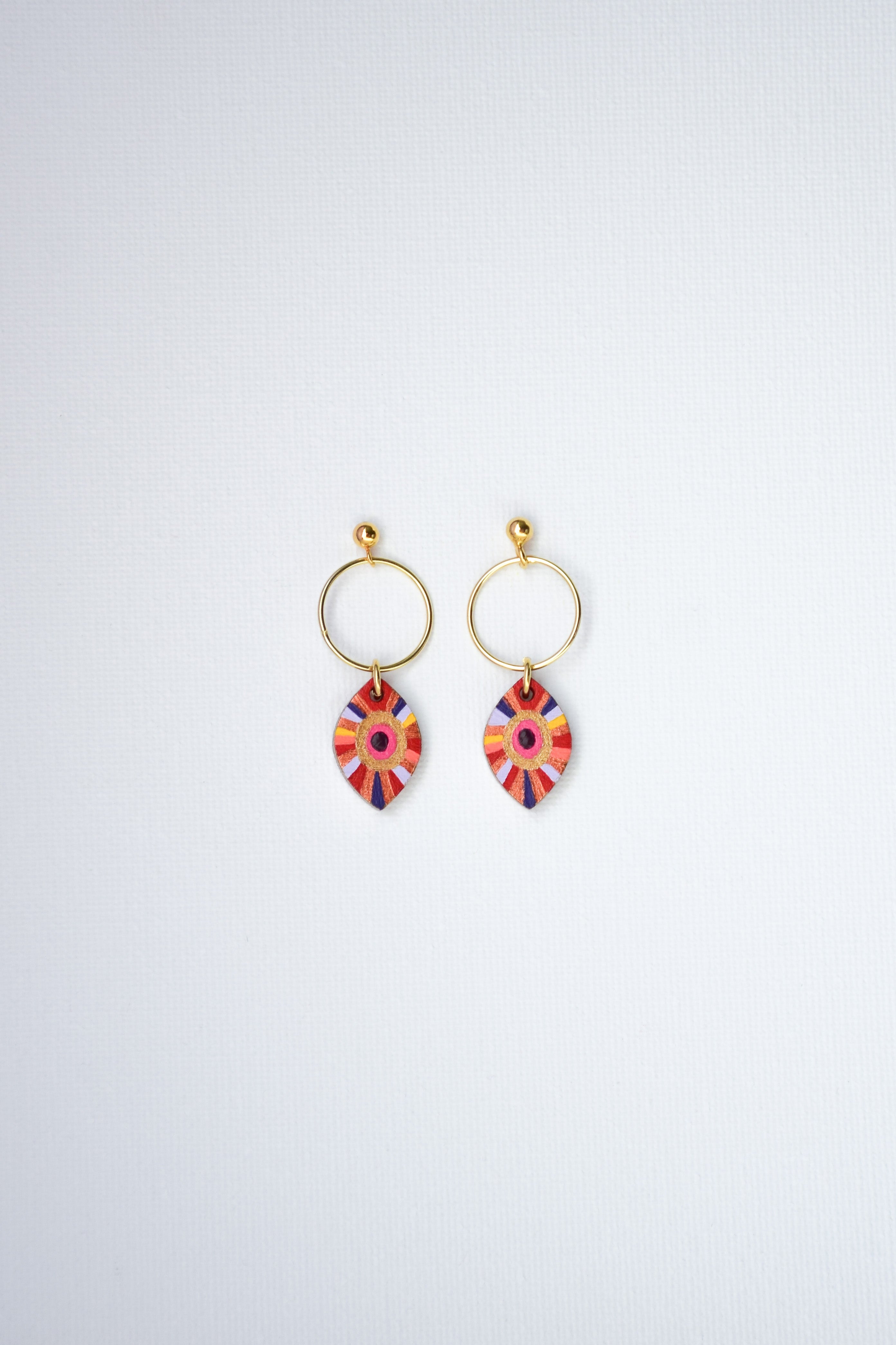 Pair of colorful hand-painted earrings with gold-plated silver hoops on a white background