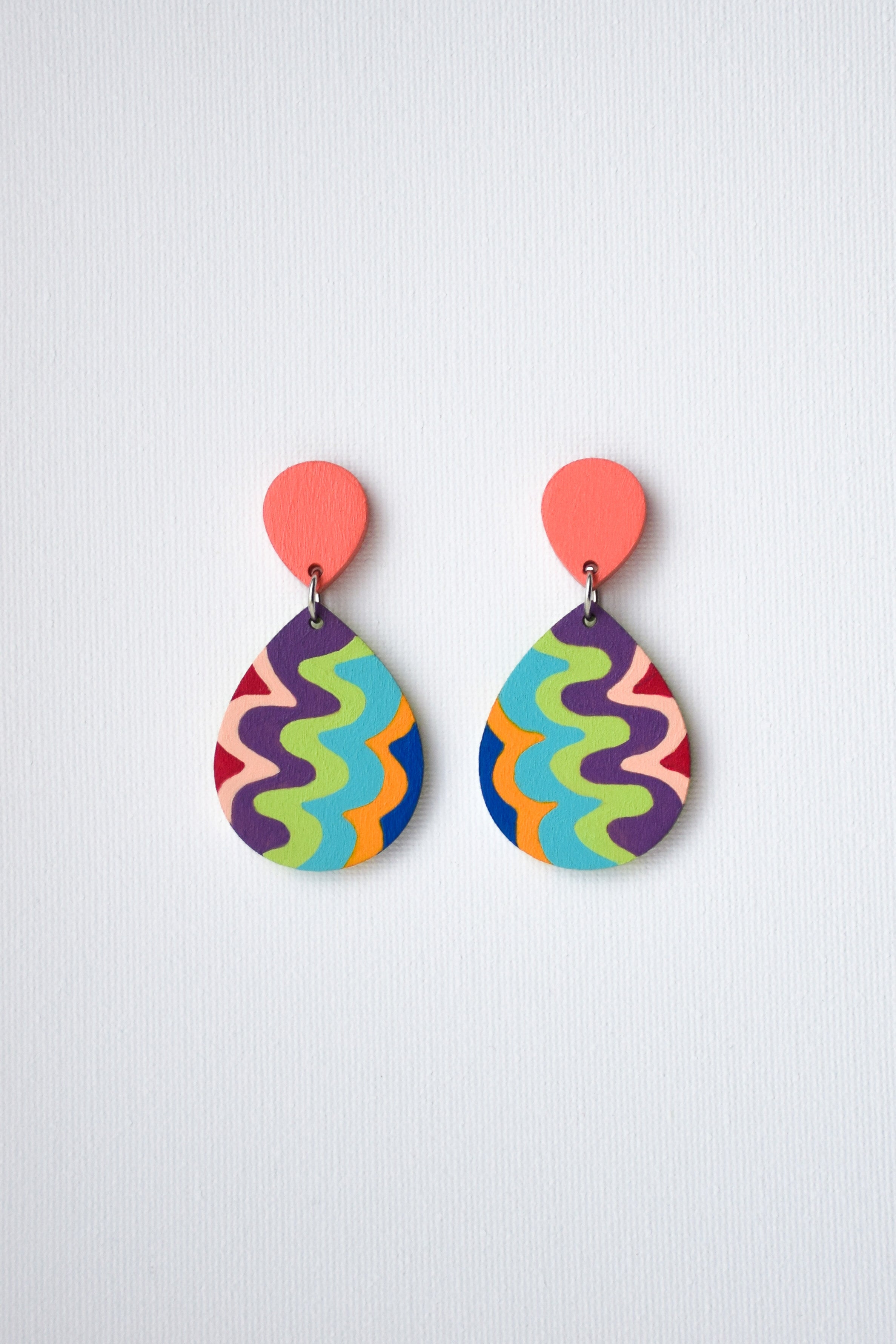 Colorful teardrop-shaped earrings on a light gray background