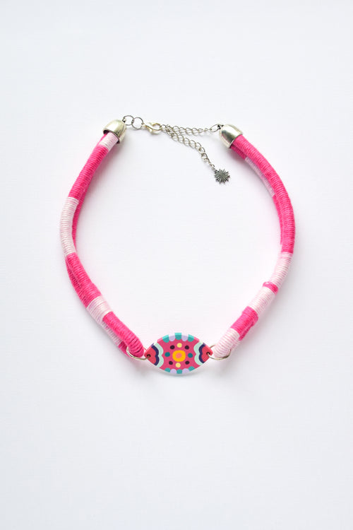 Hand-painted choker necklace featuring a decorative geometric pendant and playful colour accents.