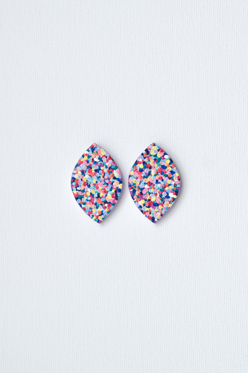 Multicolored speckled earrings on a light gray background