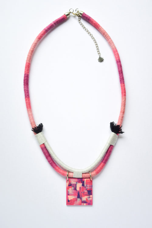 Necklace with pink and purple patterned pendant on a white background