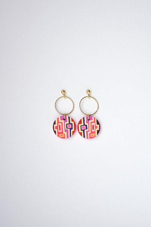 Pair of hand-painted earrings with colorful geometric designs and gold-plated silver hoops on a white background