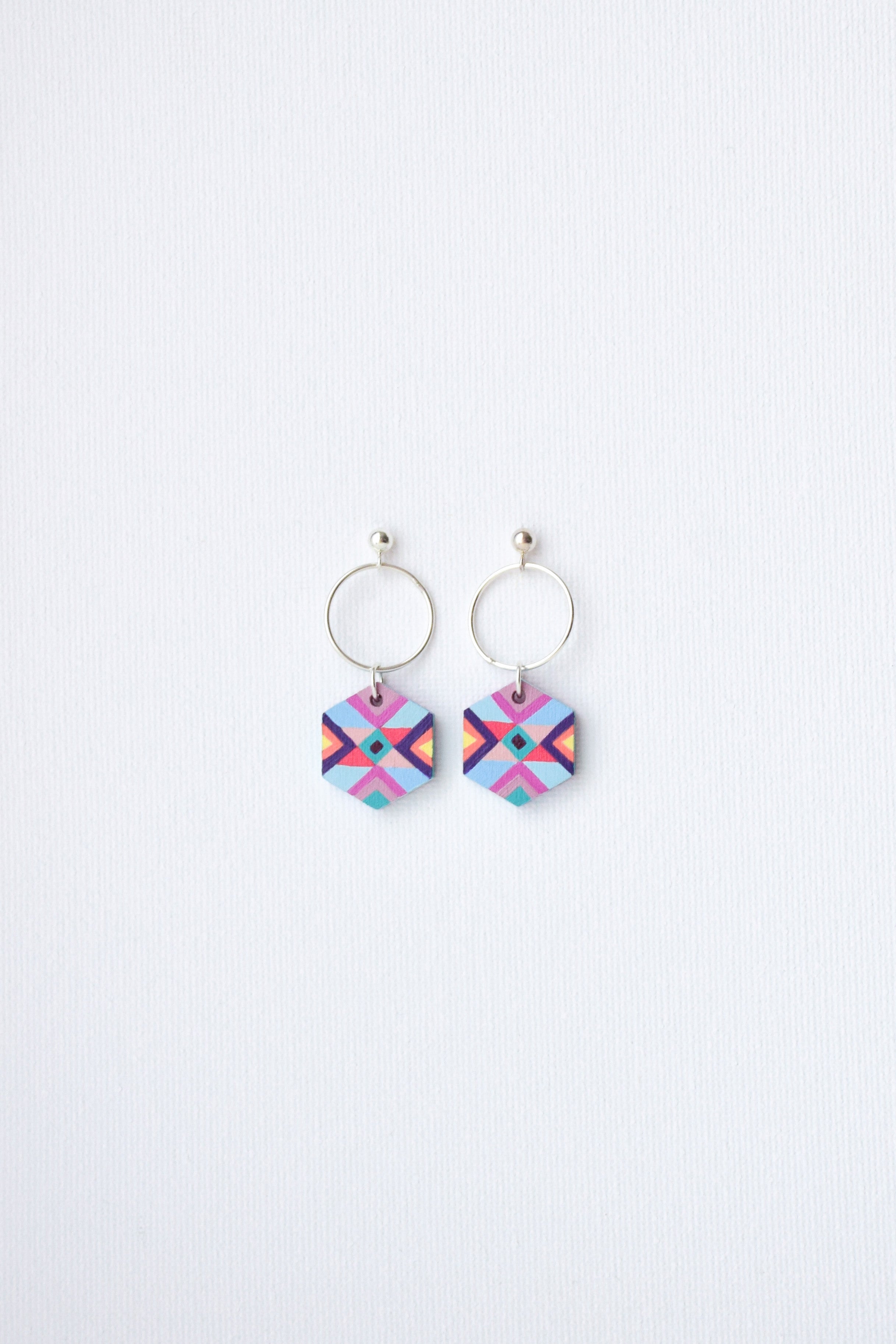 Pair of colorful geometric earrings on a white background