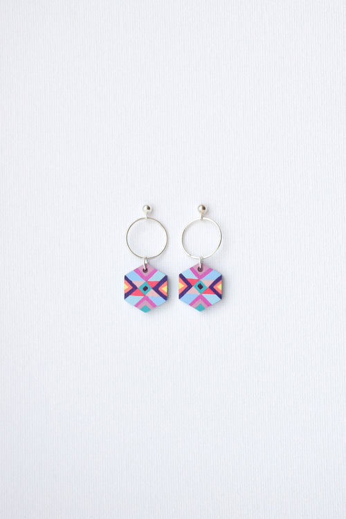Pair of colorful geometric earrings on a white background