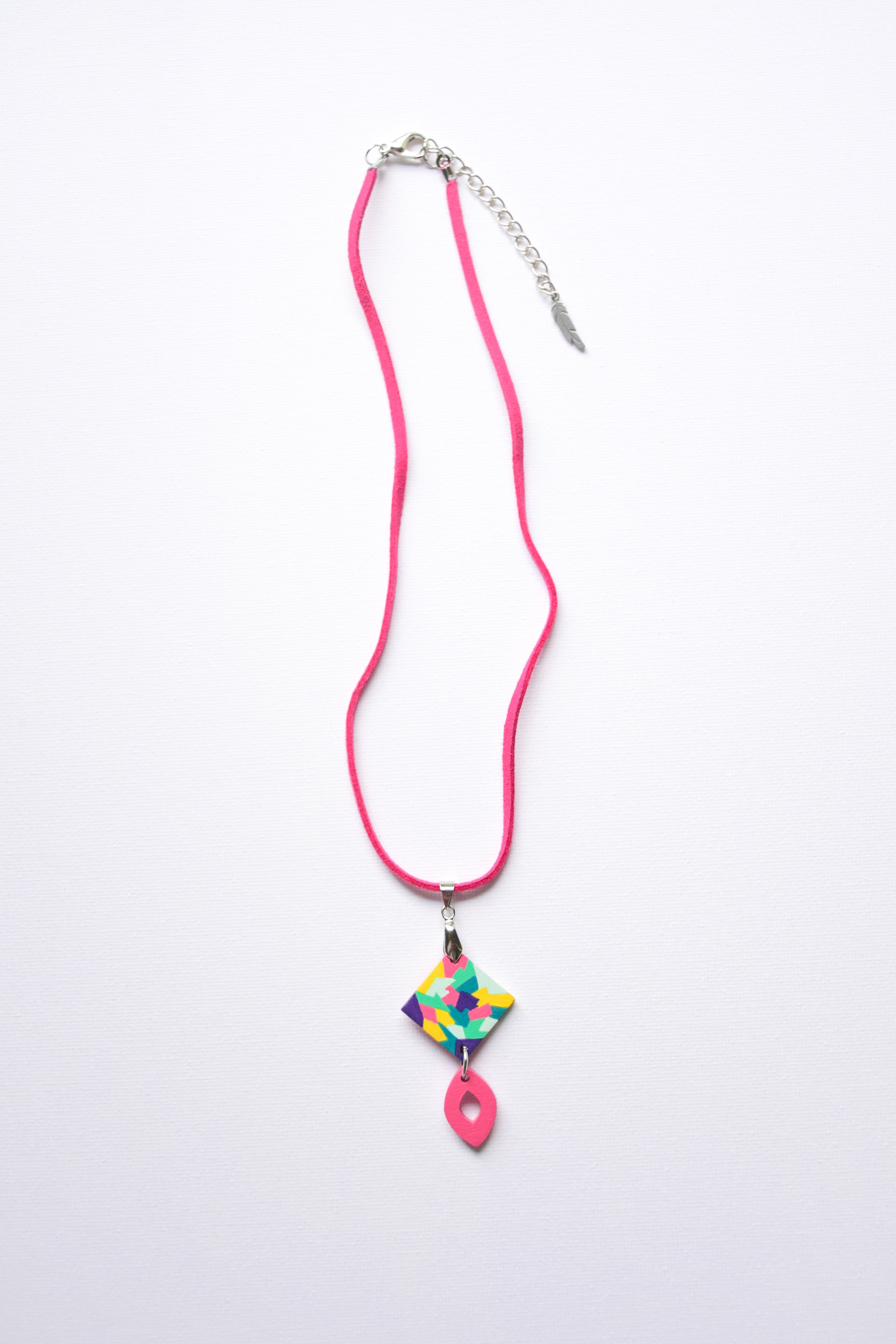 Leather cord necklace with a hand-painted colorful pendant on a white background