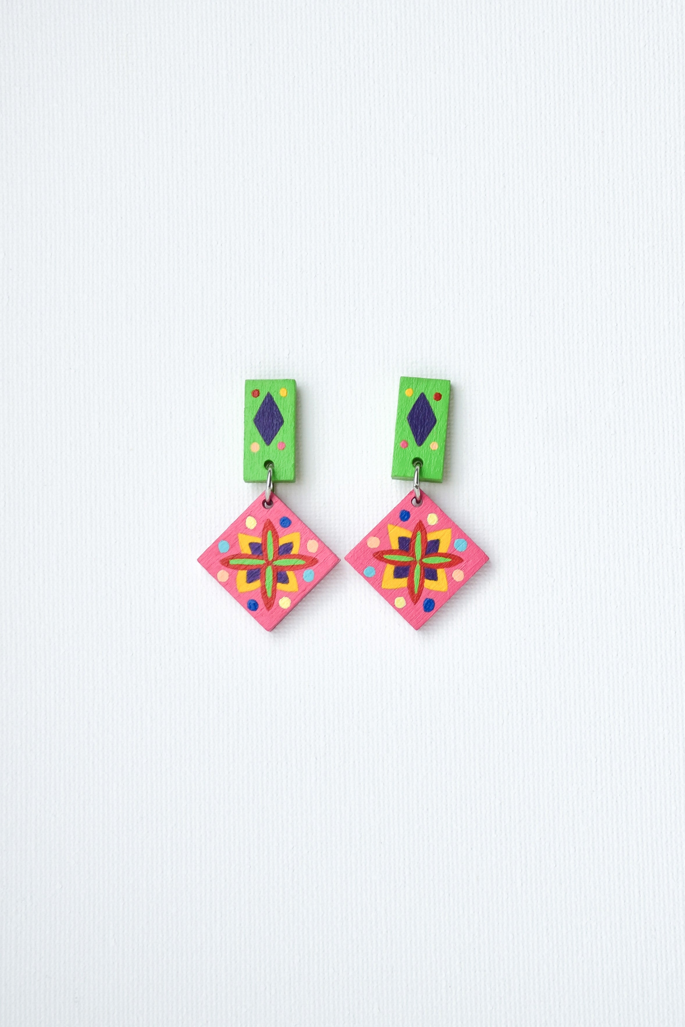 Pair of hand-painted colorful Mexican earrings on a white background